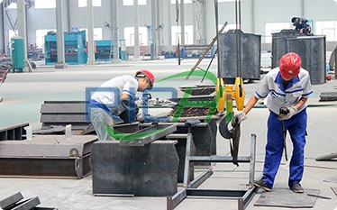 workers work in wood pellet manufacturing plant